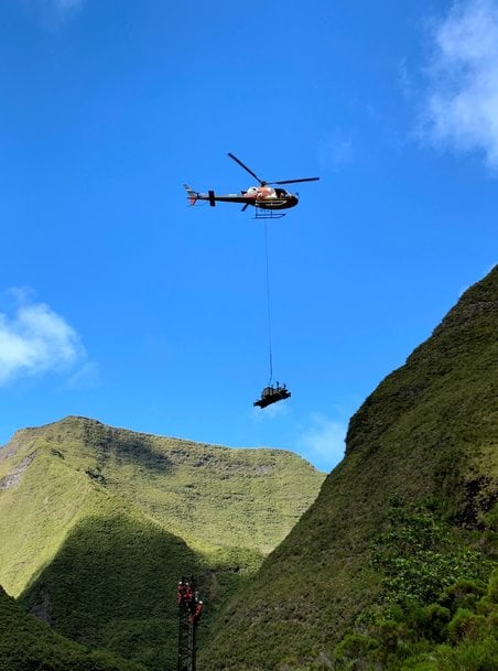 Potain MCT 58 installed by helicopter on hydroelectric dam at volcano foot